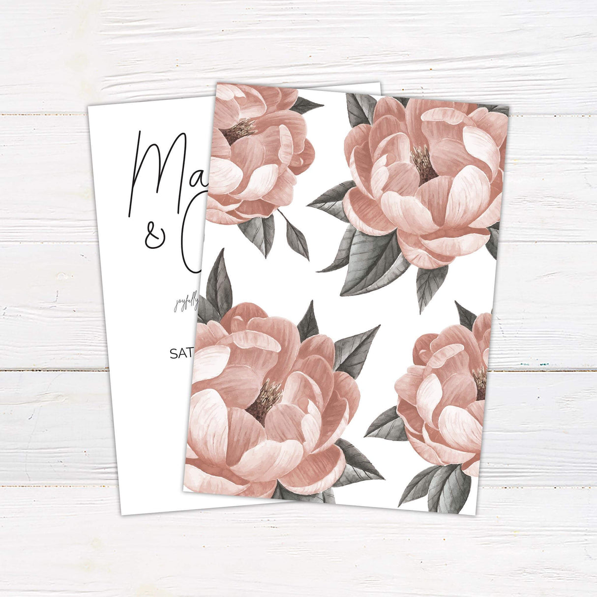 Minimalist wedding invitation with a single blush pink flower, handwritten script names, and classic serif body text on white background.- back side