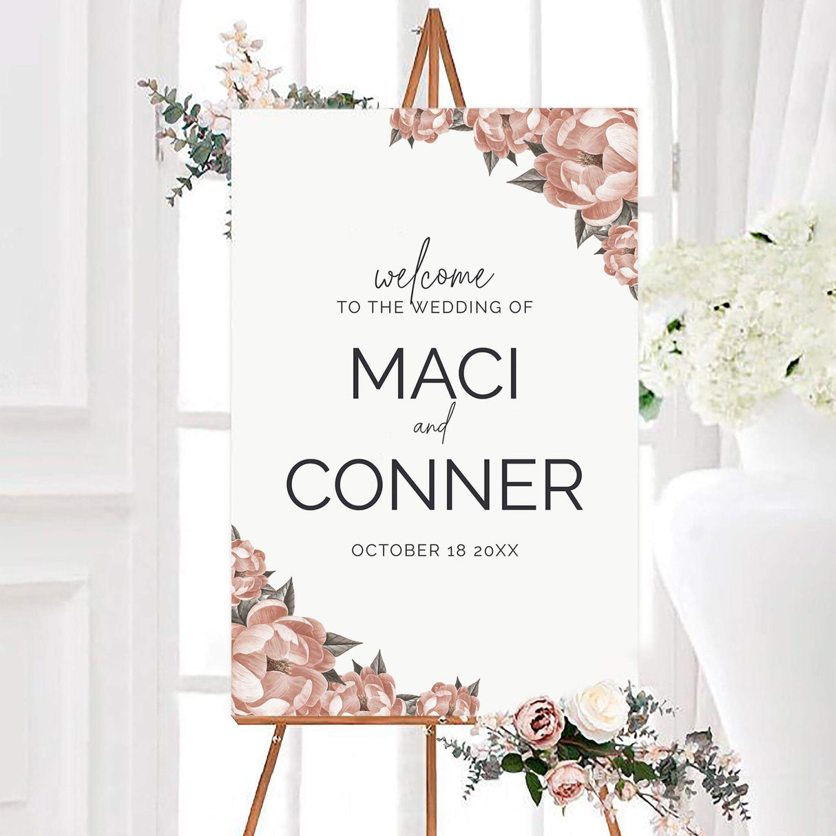 Personalized single bloom wedding welcome sign with blush pink flowers, gray-green leaves, and modern black typography on a white background. The design features the couple’s names and wedding date framed by romantic floral accents.