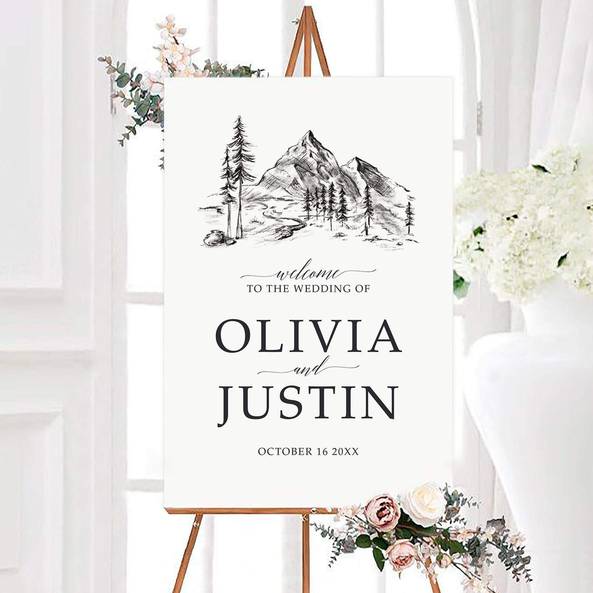 Black and white sketched mountainside wedding welcome sign featuring a hand-sketched mountain landscape with pine trees and a winding stream. The personalized design displays the couple’s names and wedding date in elegant serif and script typography.