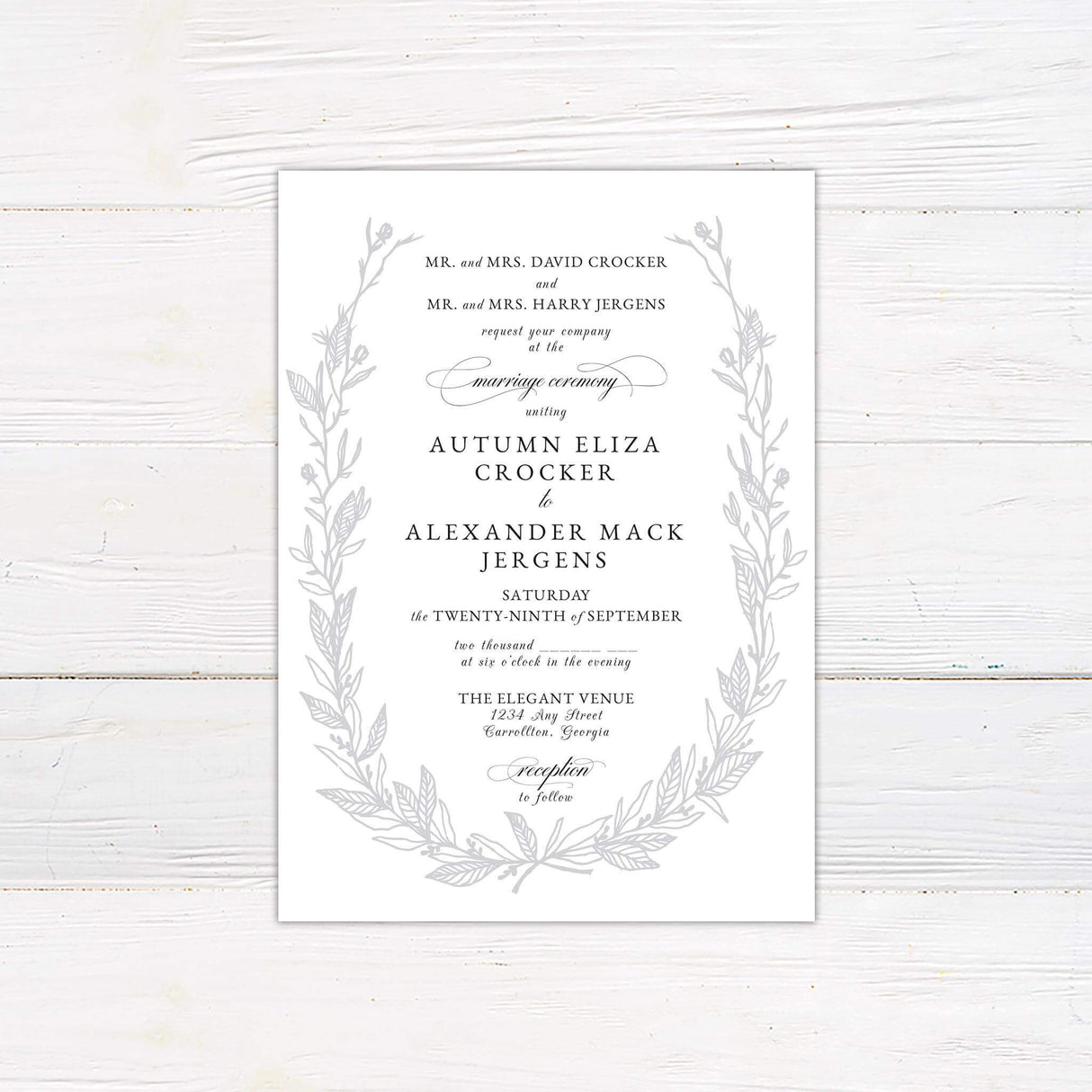 Botanical wedding invitation with soft taupe sketched vines framing classic serif and script fonts, printed on a white background.