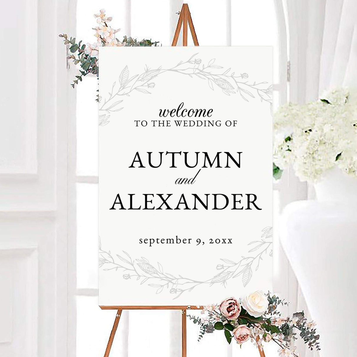 Personalized sketched vine wedding welcome sign with black typography and delicate gray sketched vines on a white background. The minimalist botanical design features the couple’s names and wedding date surrounded by leafy branches.