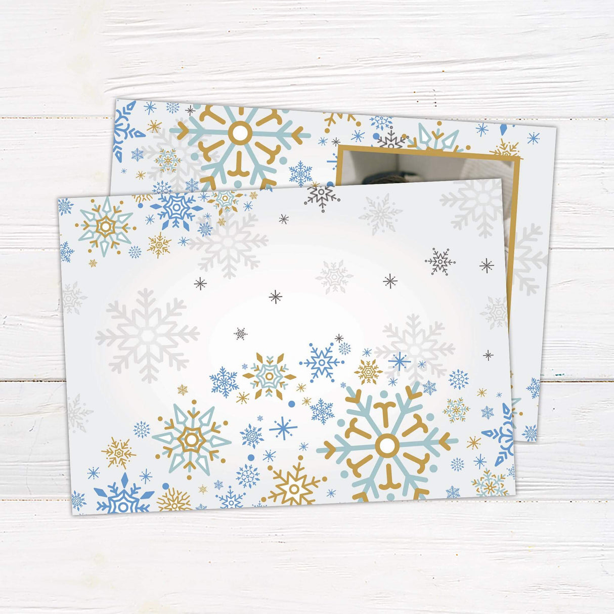 A holiday card with gold and blue snowflakes featuring a family photo. The design includes “Merry Christmas” text and customizable family name. - back.