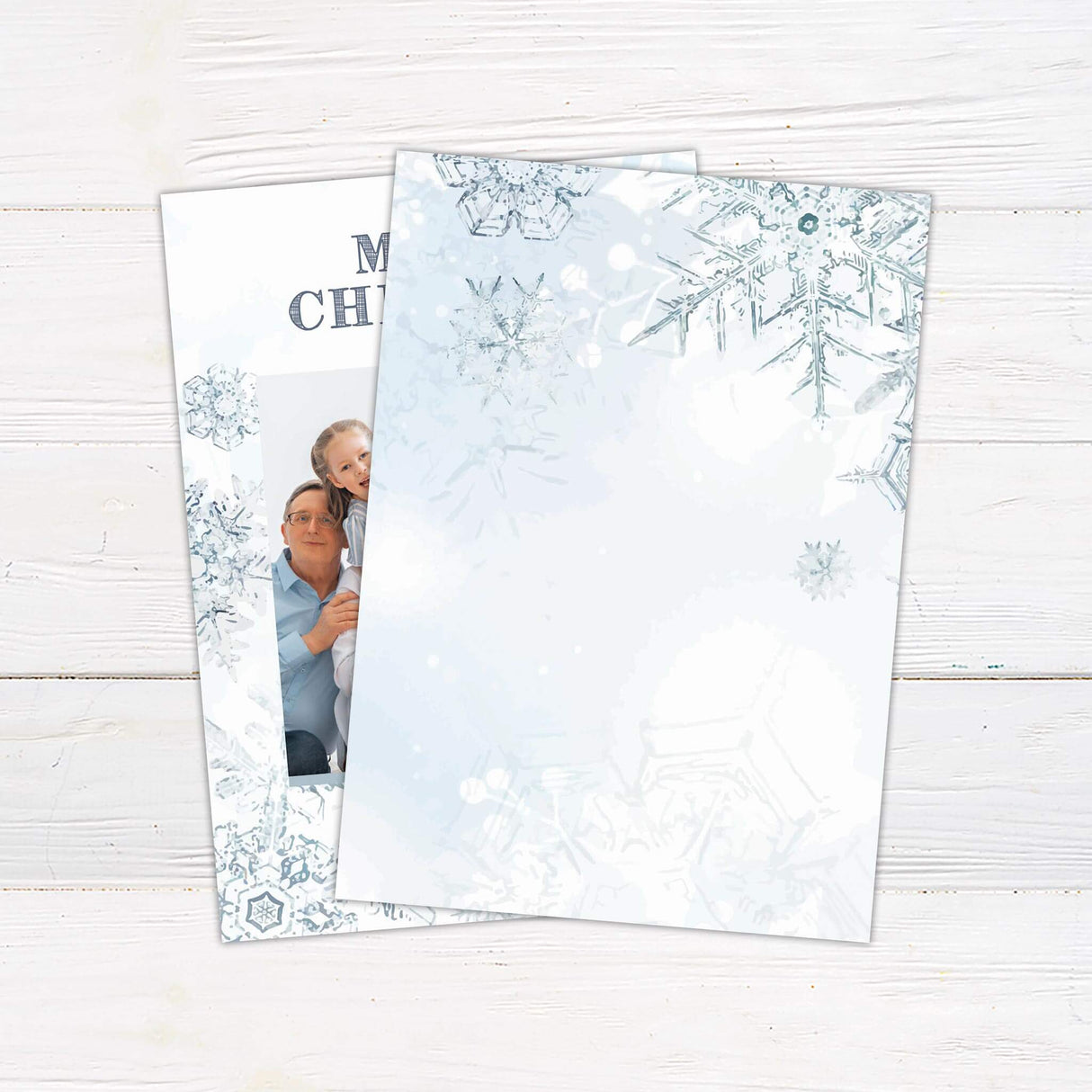 A Christmas card with snowflake designs and a family photo in the center. The card includes “Merry Christmas” with customizable family name text. - back.