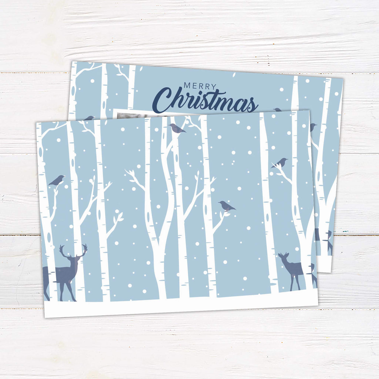 A holiday card with snowy birch trees, deer silhouettes, and a family photo in the center. The card includes “Merry Christmas” with customizable family text. - back.