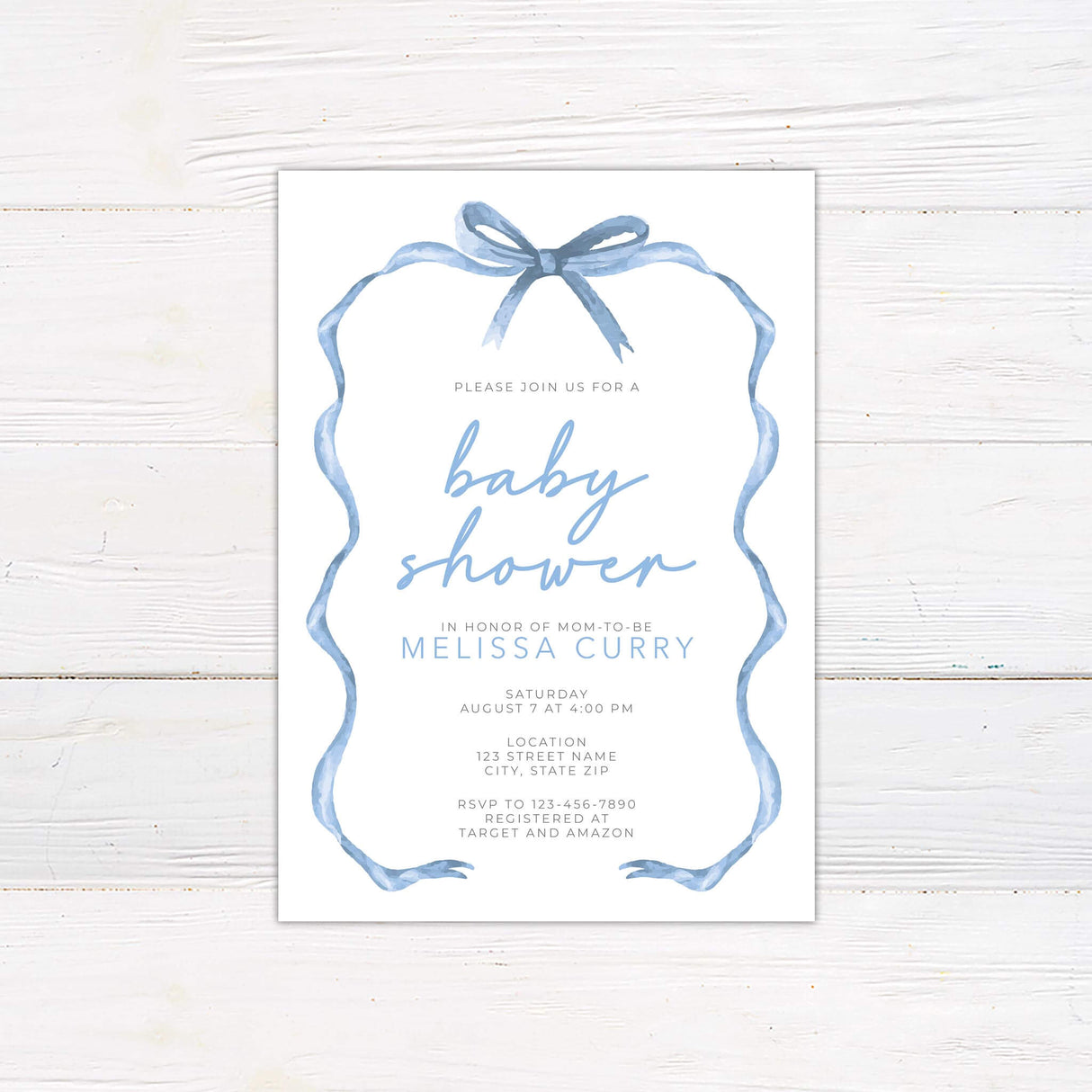 Baby shower invitation with a soft blue ribbon border and elegant script font. Features event details, RSVP information, and registry details. Perfect for celebrating an upcoming arrival.