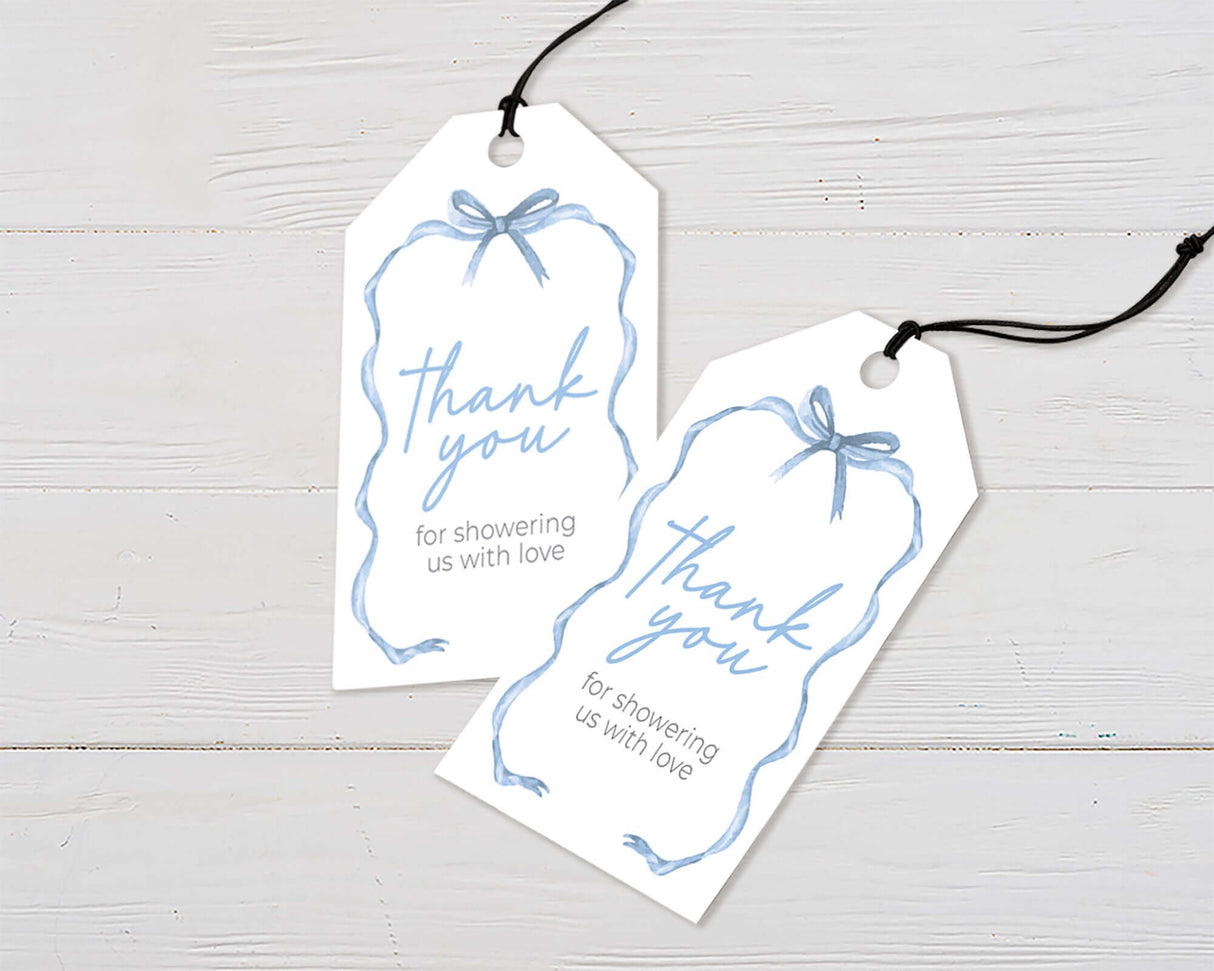 Elegant thank you tags with blue ribbon illustration on white background, perfect for baby showers and special occasions.