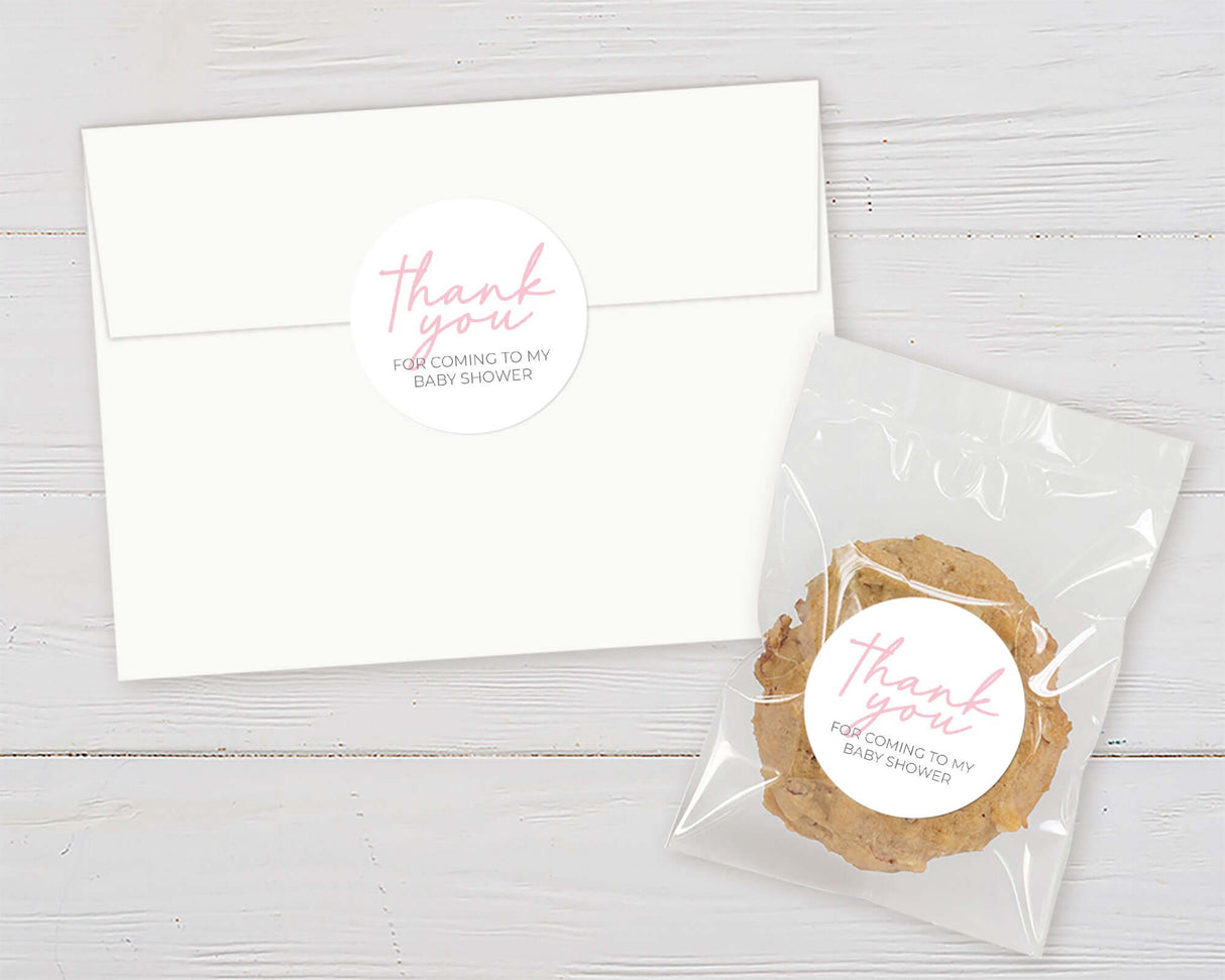 White envelope and cookie with thank you stickers for baby shower