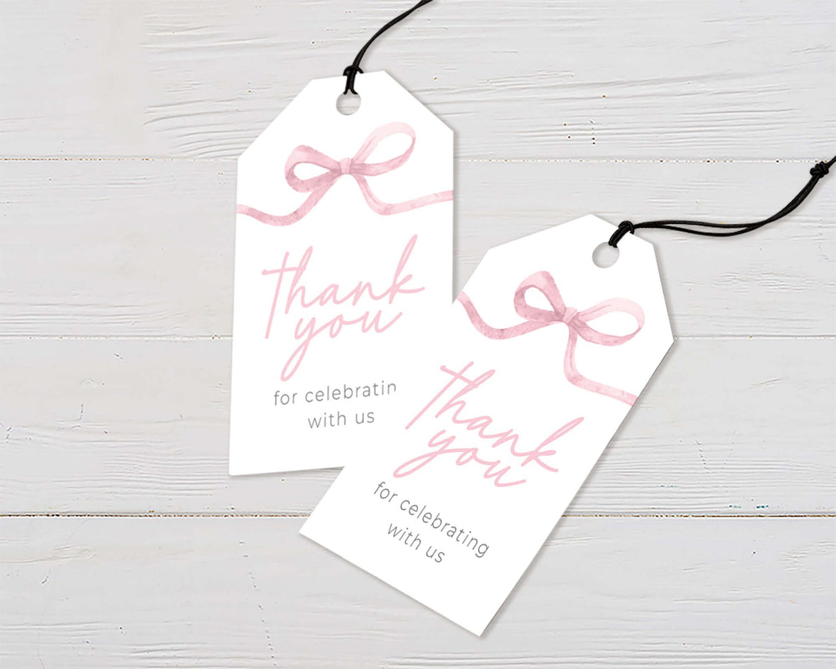 Two thank you tags with pink watercolor ribbon and elegant typography on white wood background.