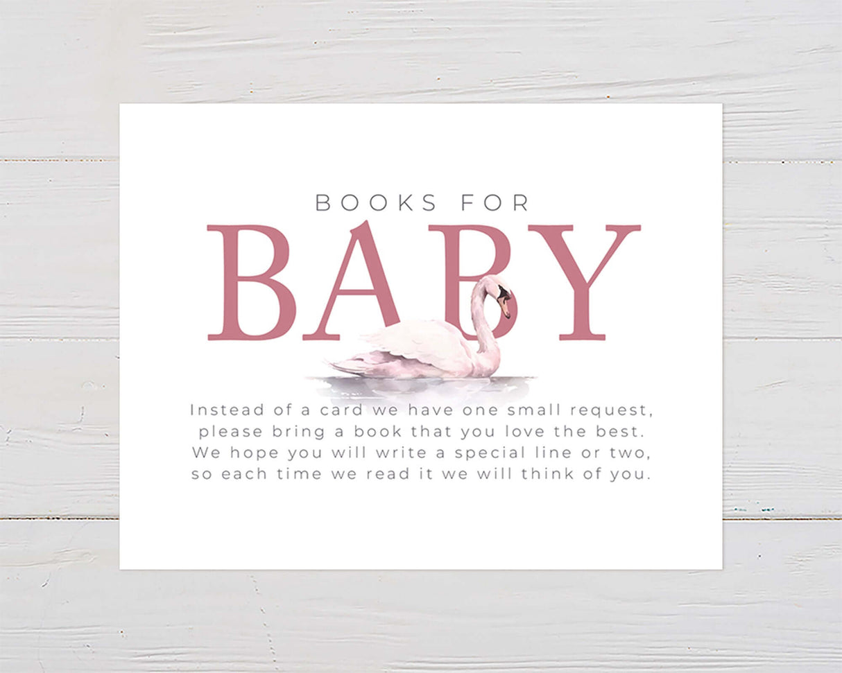 Soft pink swan baby shower invitation with elegant design on wooden background.
