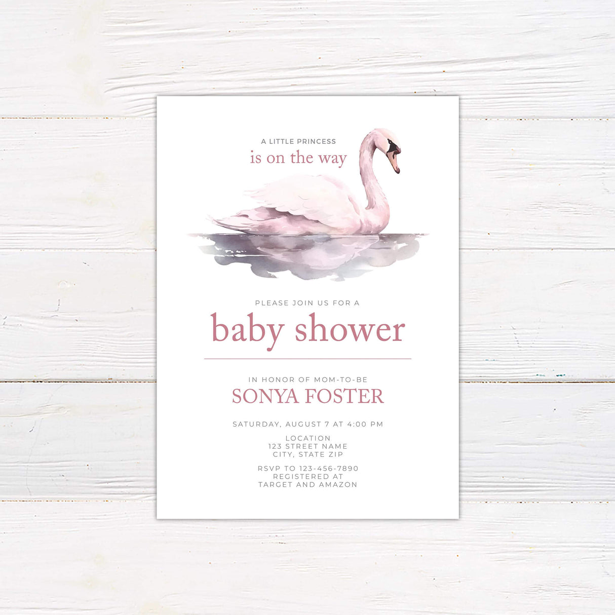Elegant baby shower invitation featuring a soft watercolor swan floating on a reflective pond. The text is in a delicate pink font, announcing the celebration of a little princess on the way. The design includes event details such as date, time, location, and registry information. The layout is clean and sophisticated, perfect for a baby shower with a graceful and feminine theme.