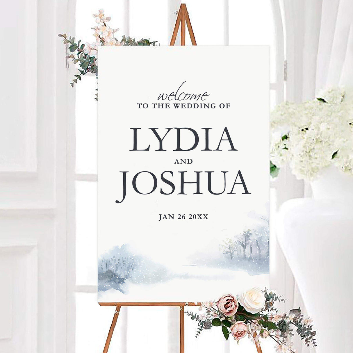 Soft snowfall wedding welcome sign featuring a soft watercolor snowy landscape with pale blue trees and falling snow. The personalized design displays the couple’s names and wedding date in elegant charcoal lettering.