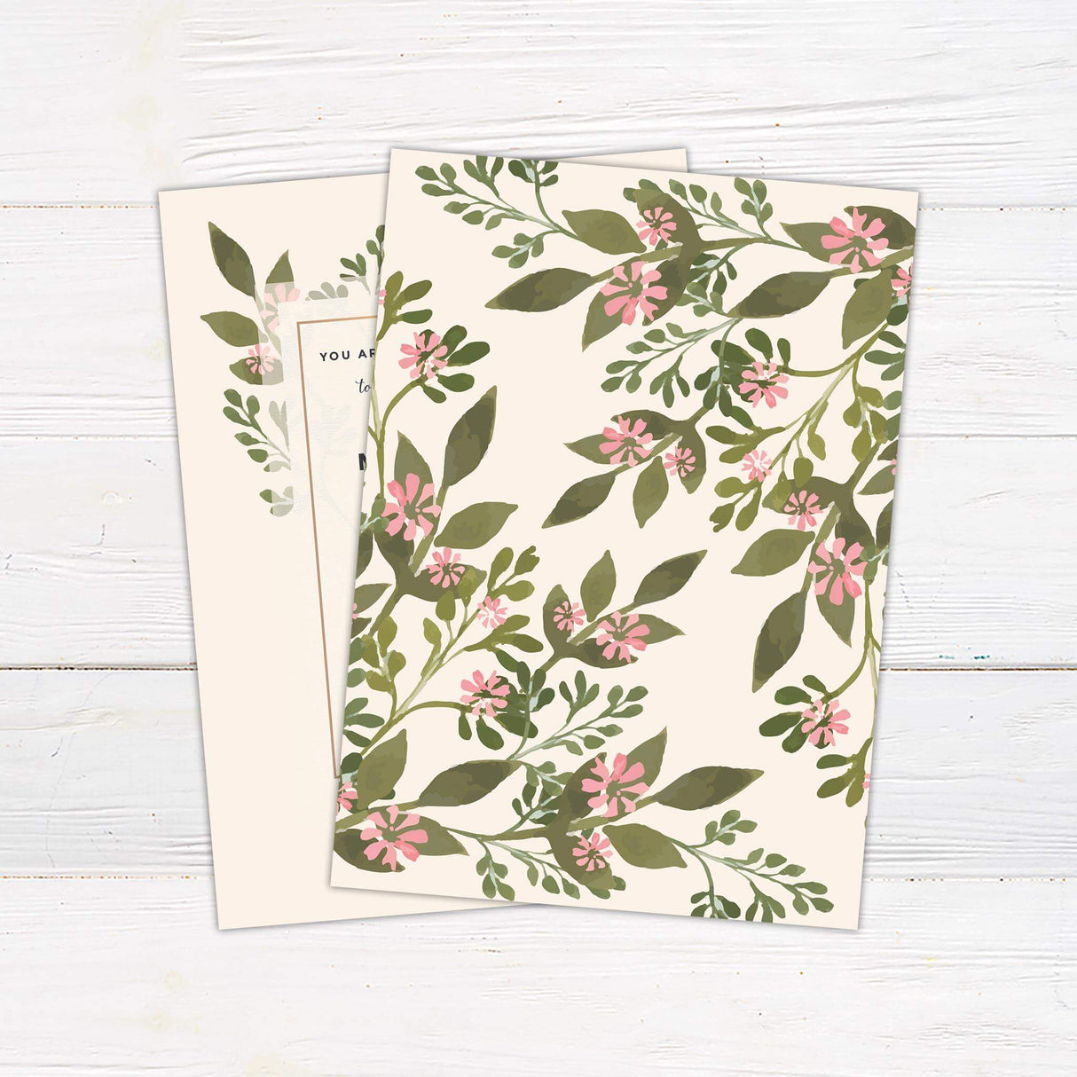 Modern botanical wedding invitation with watercolor greenery and pink floral accents on soft cream background with classic and script fonts.- back side