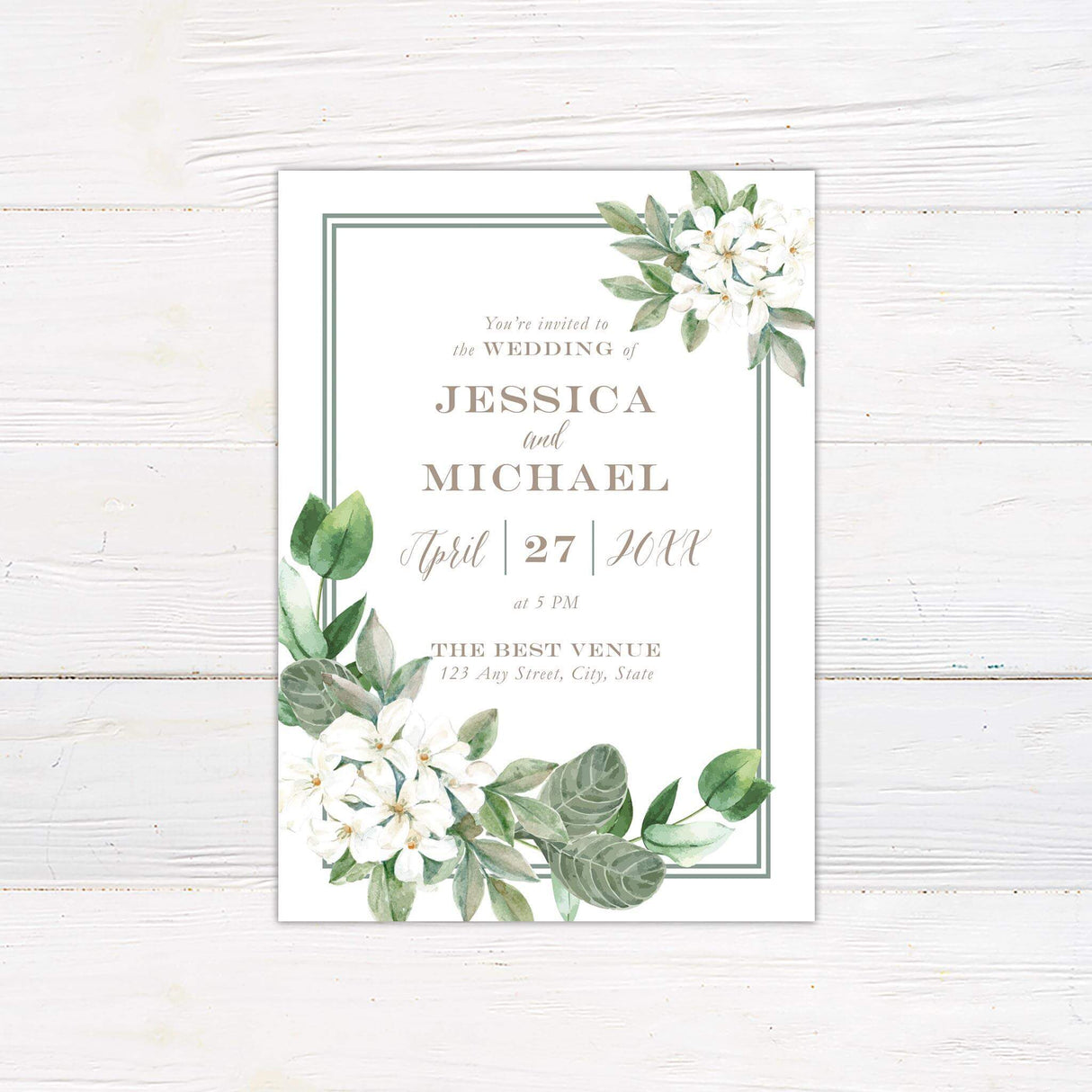Elegant wedding invitation with watercolor white florals, green foliage, and classic serif and script fonts on a cream background with a double border frame.