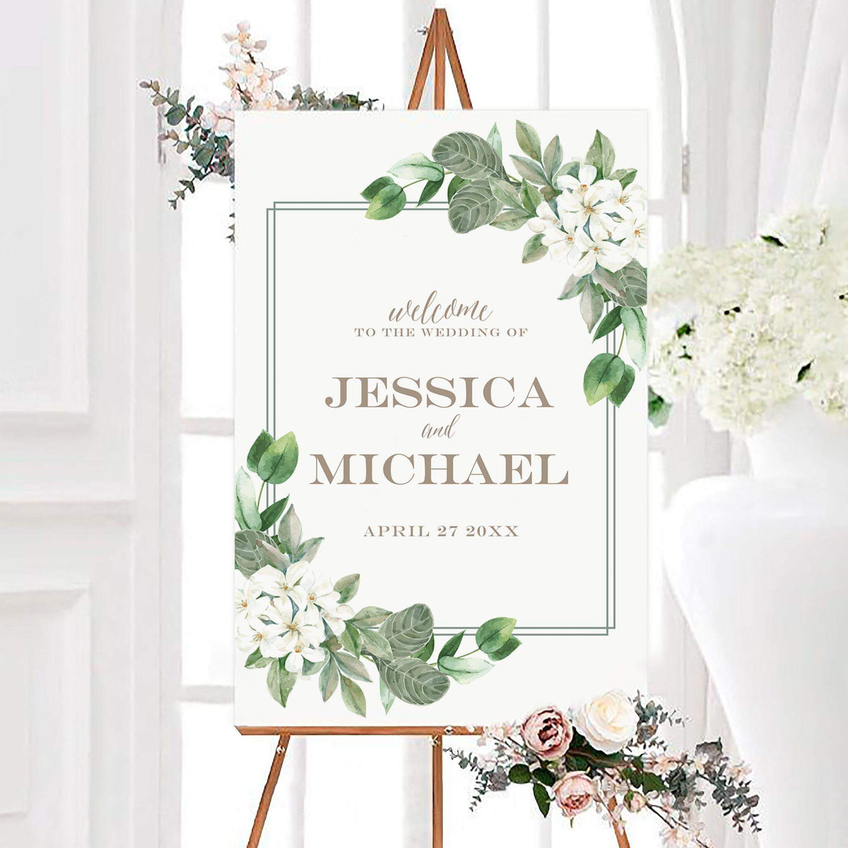 Southern belle wedding welcome sign with watercolor white flowers, green foliage, and a thin double-line border on a white background. Elegant neutral lettering displays the couple’s names and wedding date.