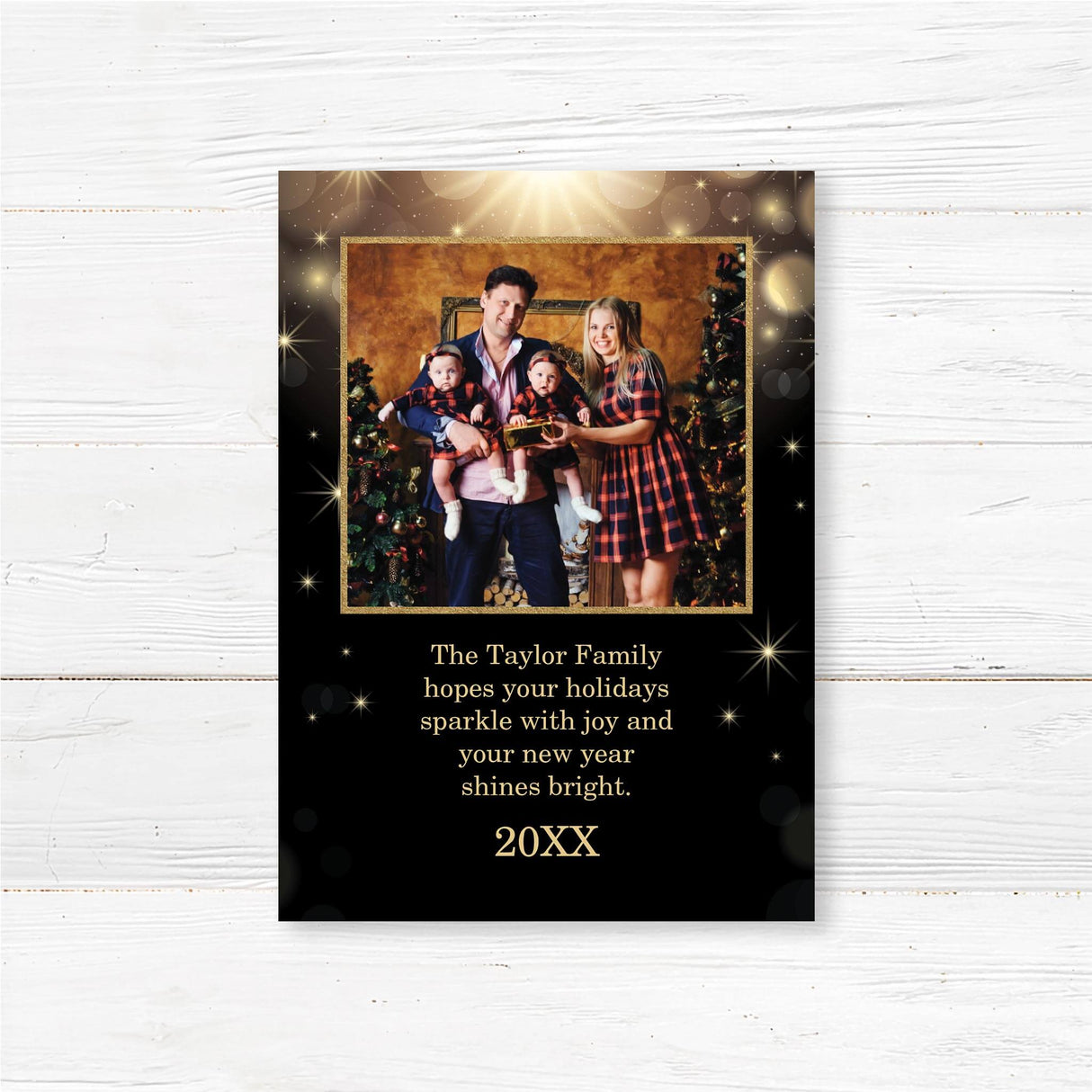 A personalized black and gold Christmas card featuring a family photo surrounded by sparkling lights and snowflakes. Includes festive holiday text and family greeting.