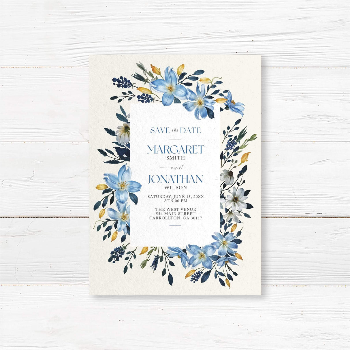 Personalized save the date card with blue watercolor floral accents, printed on luxury textured cardstock. This custom save the date announcement is perfect for elegant, rustic, or destination weddings, ensuring your guests mark their calendars in style. The chic botanical artwork and classic typography add a romantic, timeless touch to your wedding stationery suite.