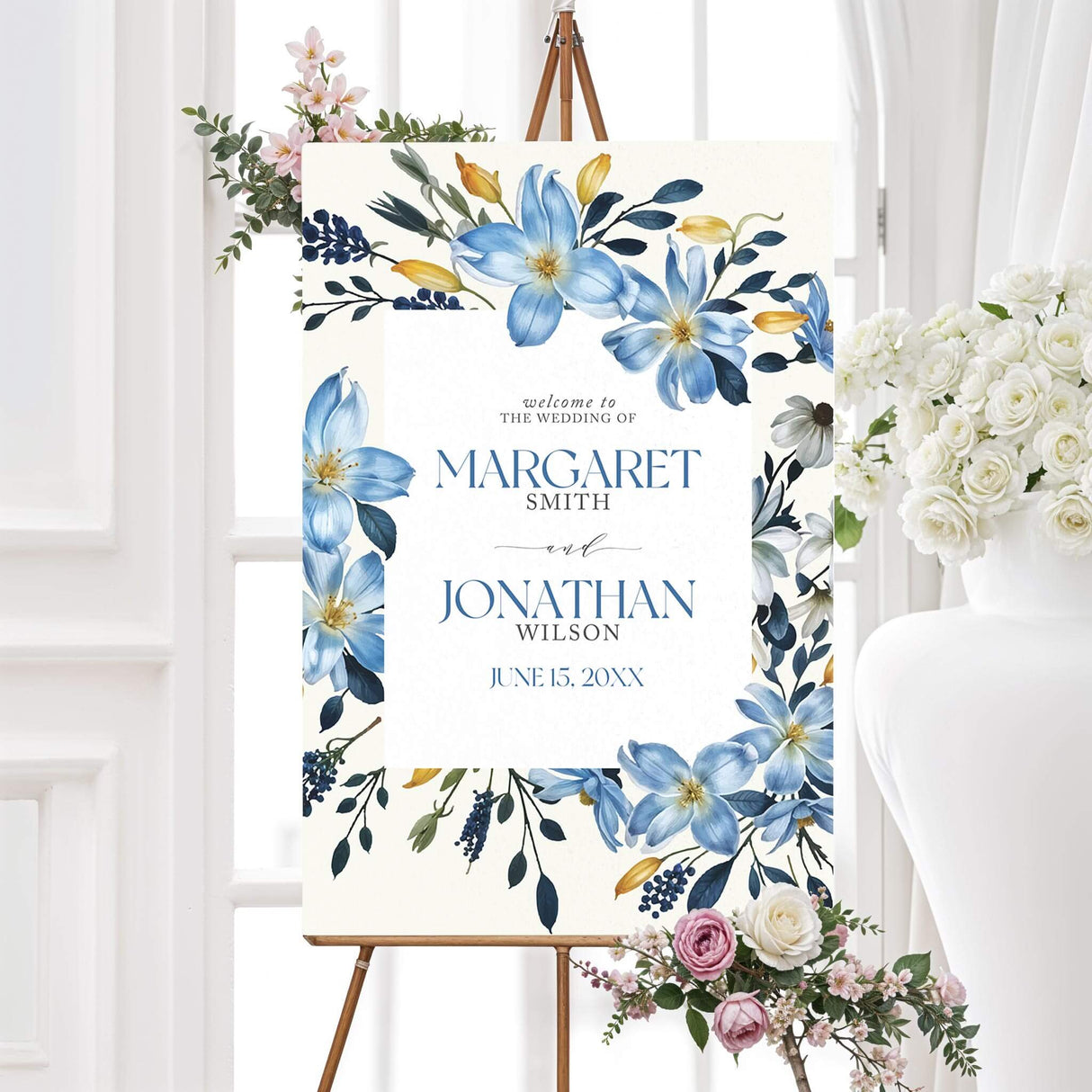 Custom wedding welcome sign featuring blue watercolor floral arrangements and classic calligraphy. Available in foam board or poster format, this large wedding entrance sign greets guests in a stylish and elegant way. Perfect for outdoor garden weddings, formal ballroom receptions, or bohemian events, the floral artwork complements a range of romantic wedding themes.