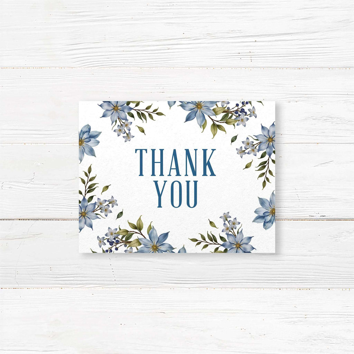 Beautiful floral wedding thank you card with soft blue watercolor flowers and elegant script. Printed on premium textured cardstock with a customizable message.