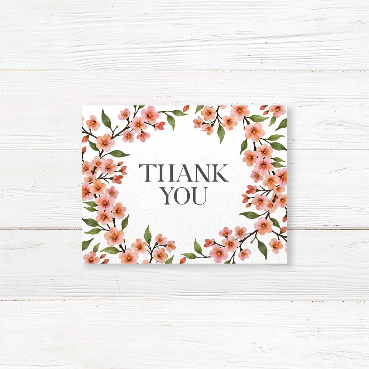 Floral wedding thank you card with delicate cherry blossom design and stylish script typography. Printed on high-quality cardstock with matching envelopes. Available in folded or flat formats. A heartfelt way to express gratitude for weddings, bridal showers, and engagements.