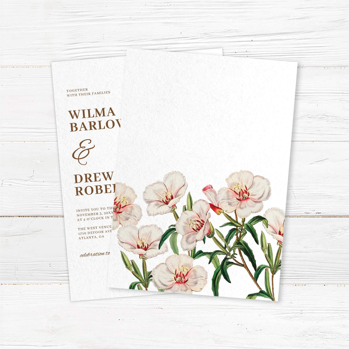 Wedding invitation back with delicate watercolor flowers in soft blush and ivory tones, paired with classic serif fonts on textured white cardstock. Elegant spring botanical design from the Spring in Bloom stationery suite.