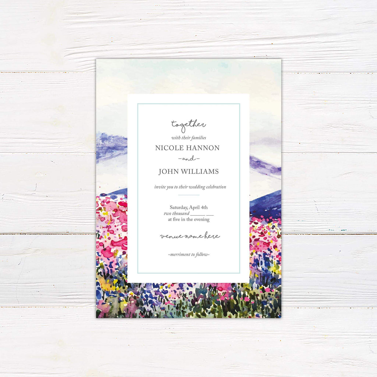 Spring wedding invitation with watercolor wildflower field and mountain landscape, featuring elegant serif and script fonts.