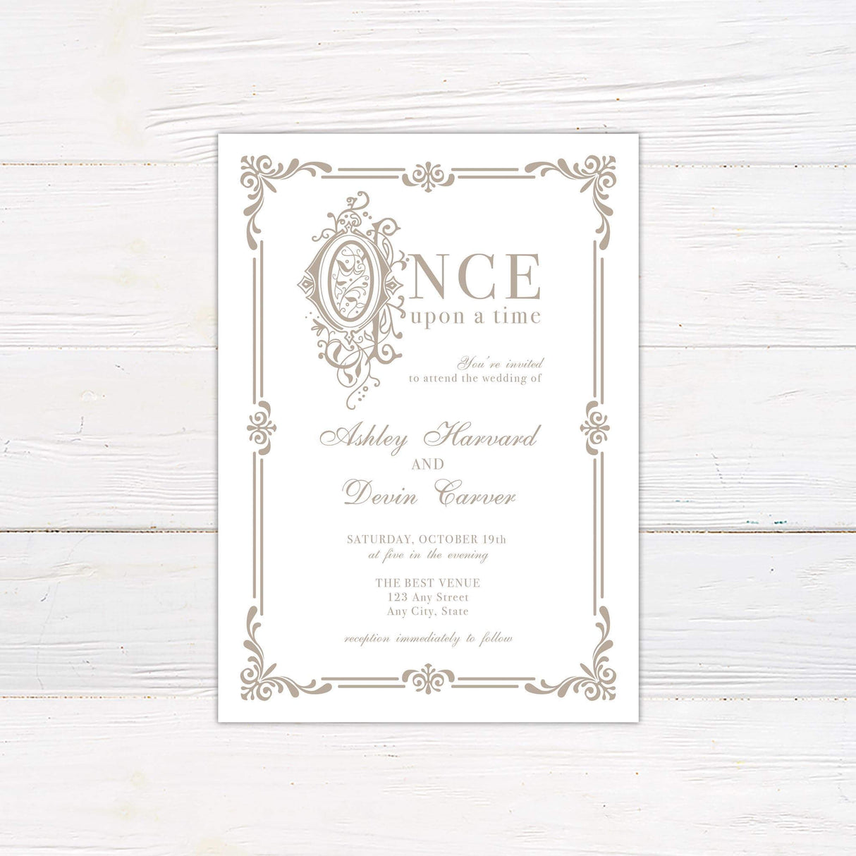 Storybook wedding invitation with “Once Upon a Time” heading and ornate beige scrollwork frame on white background, featuring elegant serif and script fonts.