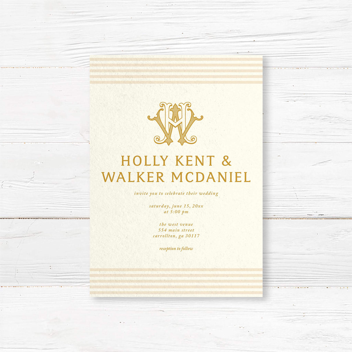 Elegant cream and gold wedding invitation featuring a decorative gold monogram crest at the top, horizontal neutral stripes on the top and bottom edges, and classic serif typography, ideal for formal weddings.