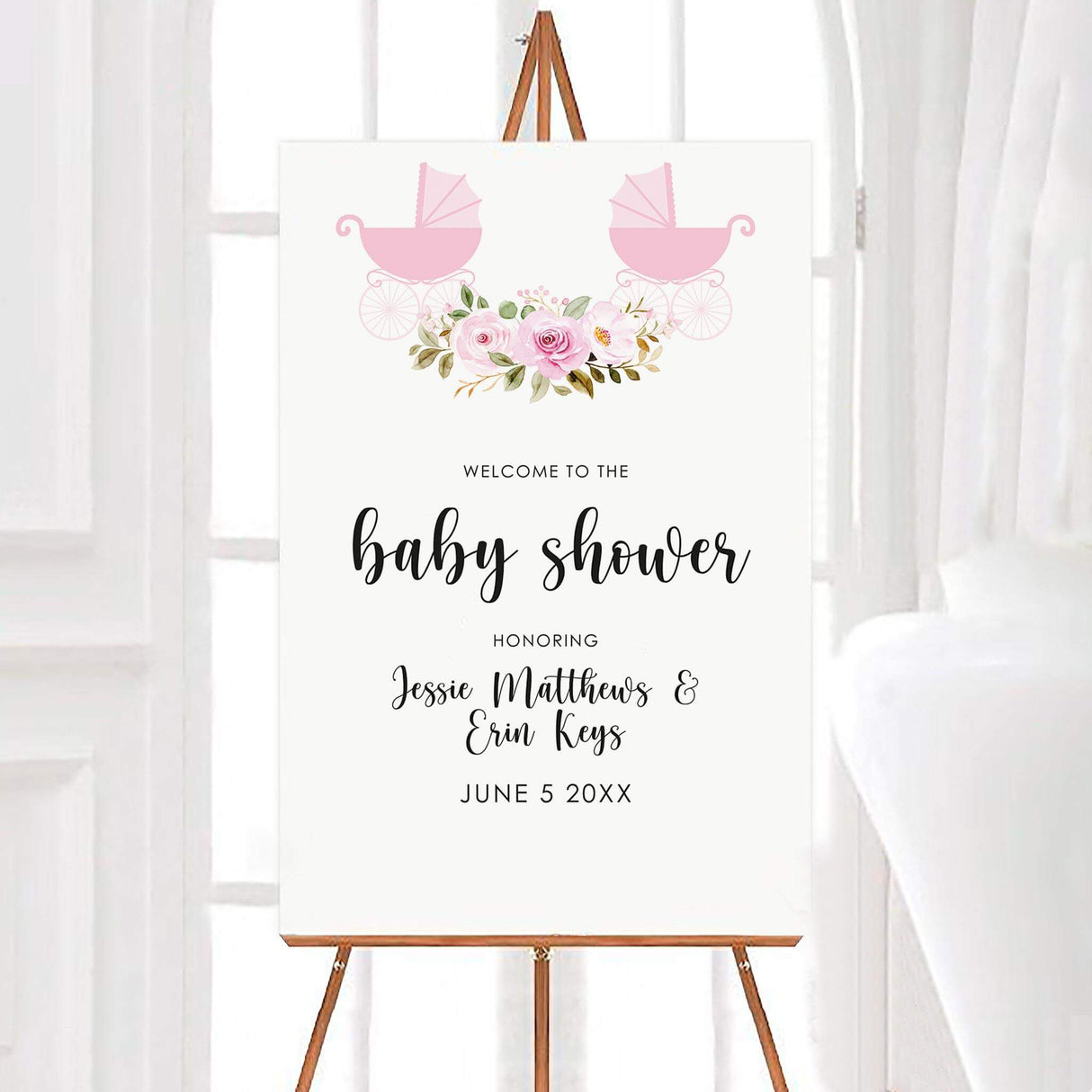 Welcome sign for best friends baby shower featuring pink baby carriages, a floral arrangement, and elegant script on a white background. The design includes soft pastel colors and delicate typography, creating a warm and celebratory feel. Highlighting both mom's to be names.