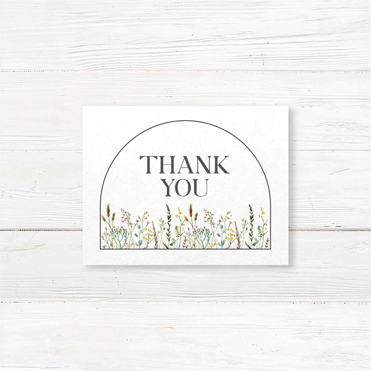 Floral wedding thank you card with delicate wildflower illustrations and stylish calligraphy text. Printed on premium cardstock with matching envelopes. Available in folded or flat formats. A heartfelt way to express gratitude for weddings, bridal showers, and engagements.