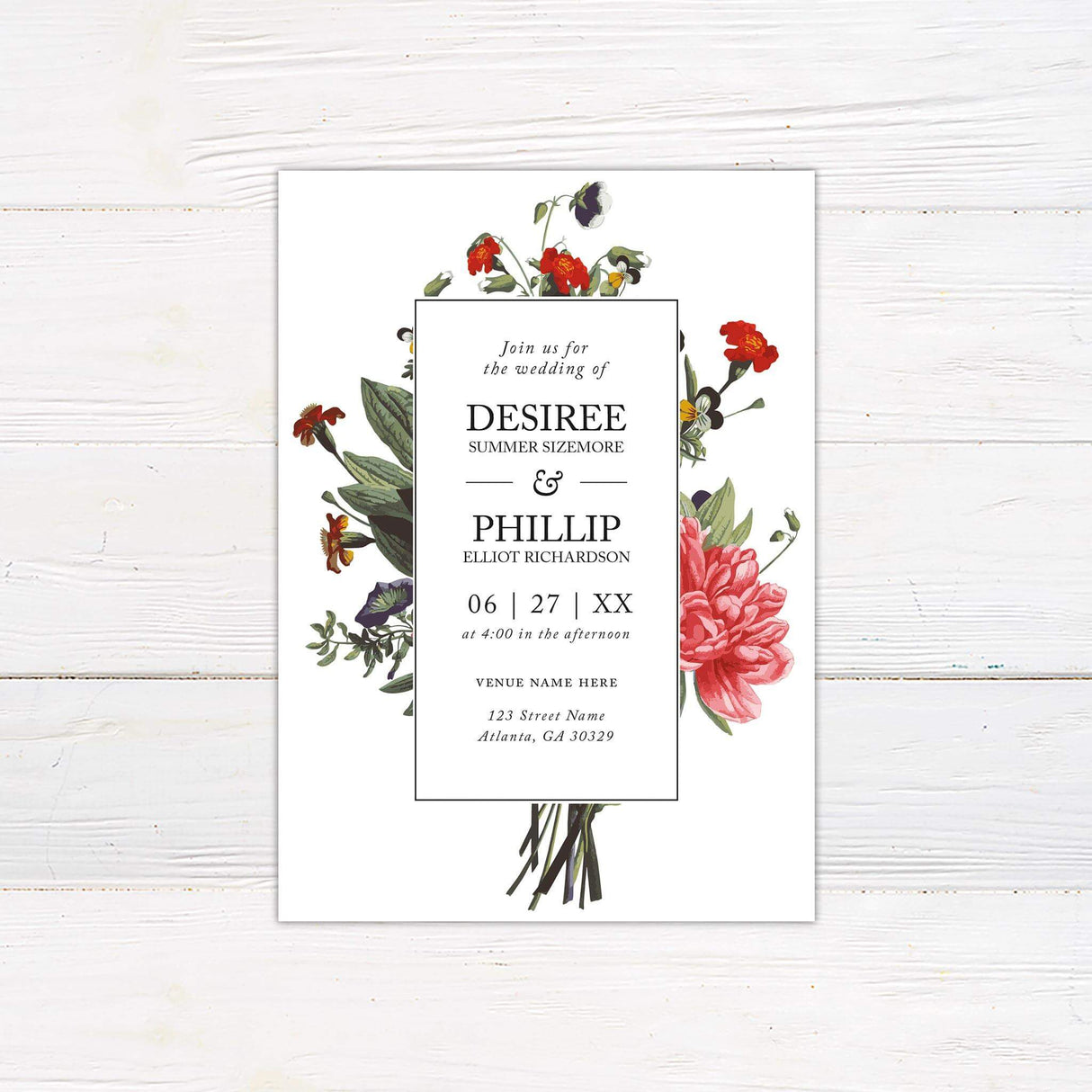 Wedding invitation with a bold bouquet of colorful summer florals surrounding a white text panel with serif and script fonts.