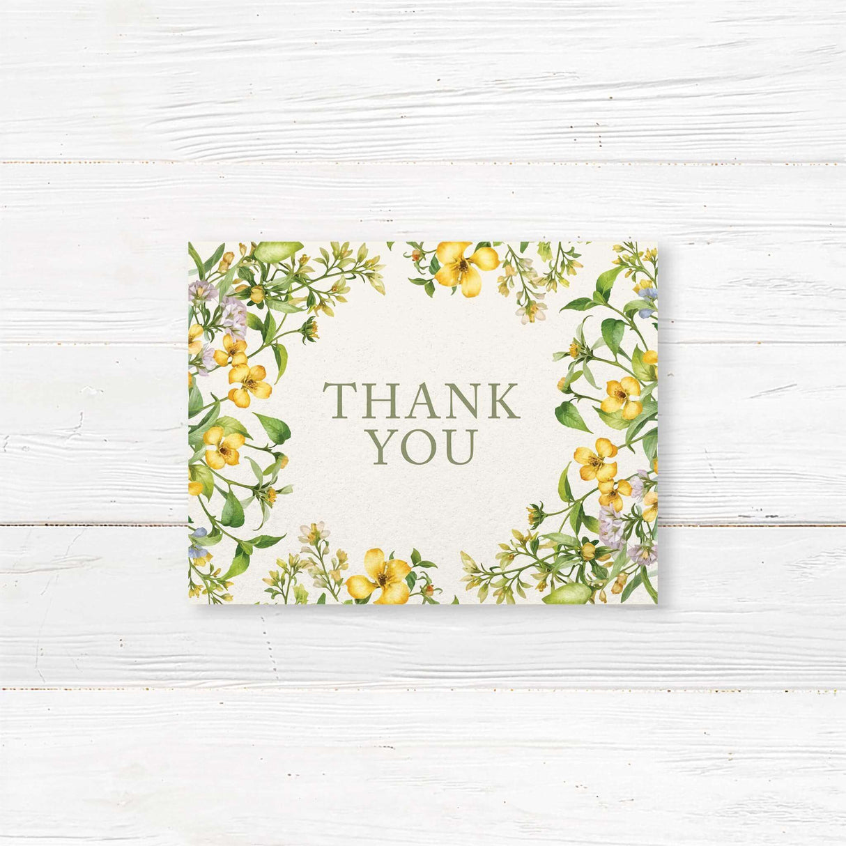 Elegant note card with a floral design featuring yellow and white flowers intertwined with green leaves. The text is in a sophisticated serif font.