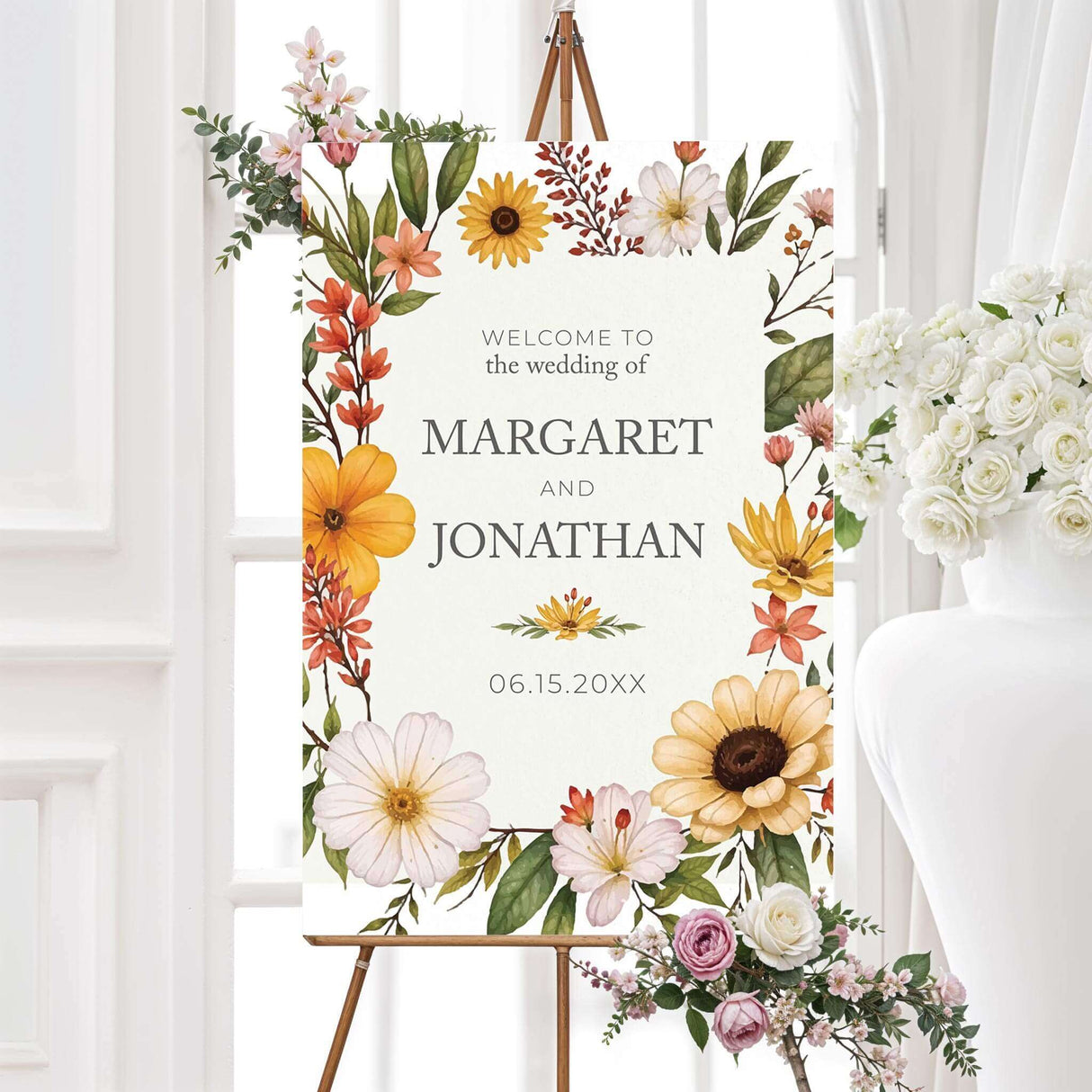 Elegant sign with a watercolor-style floral border featuring sunflowers, daisies, and wildflowers in warm shades of yellow, orange, and white. The design has a soft, natural aesthetic with delicate typography centered within the floral frame, creating a romantic and timeless look.
