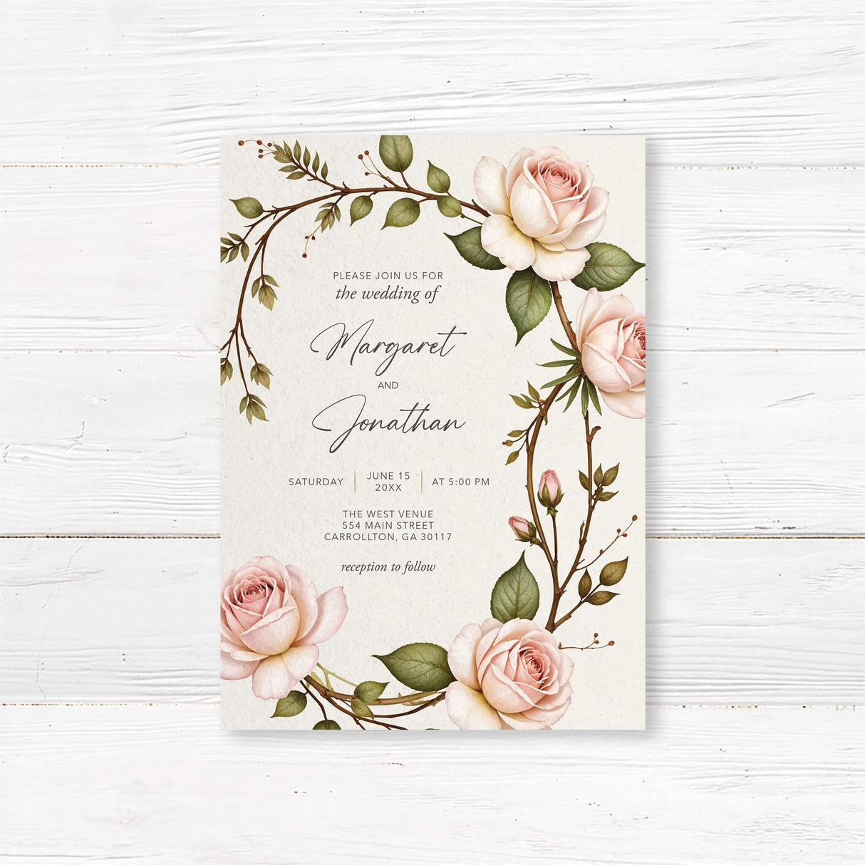 Elegant wedding invitation featuring a romantic watercolor floral design with soft blush pink roses and lush green leaves. A delicate arched floral frame surrounds the modern typography, perfect for classic, vintage, and garden weddings.