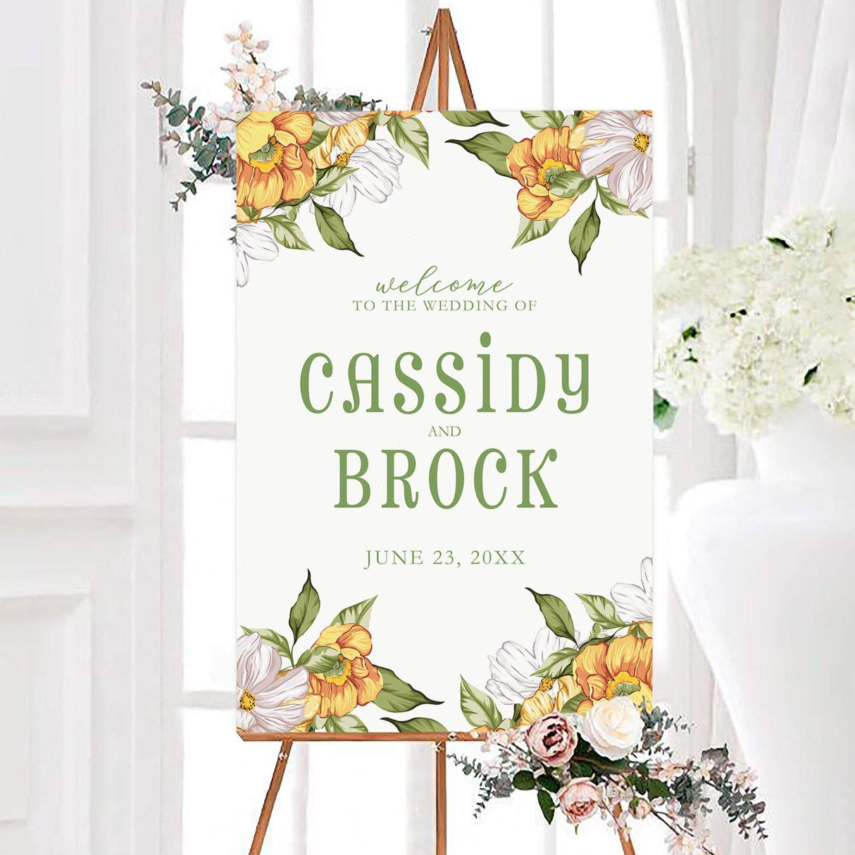 Personalized summer harvest wedding welcome sign featuring orange, yellow, and white garden flowers with green leaves around the top and bottom. Green script and serif lettering displays the couple’s names and wedding date.