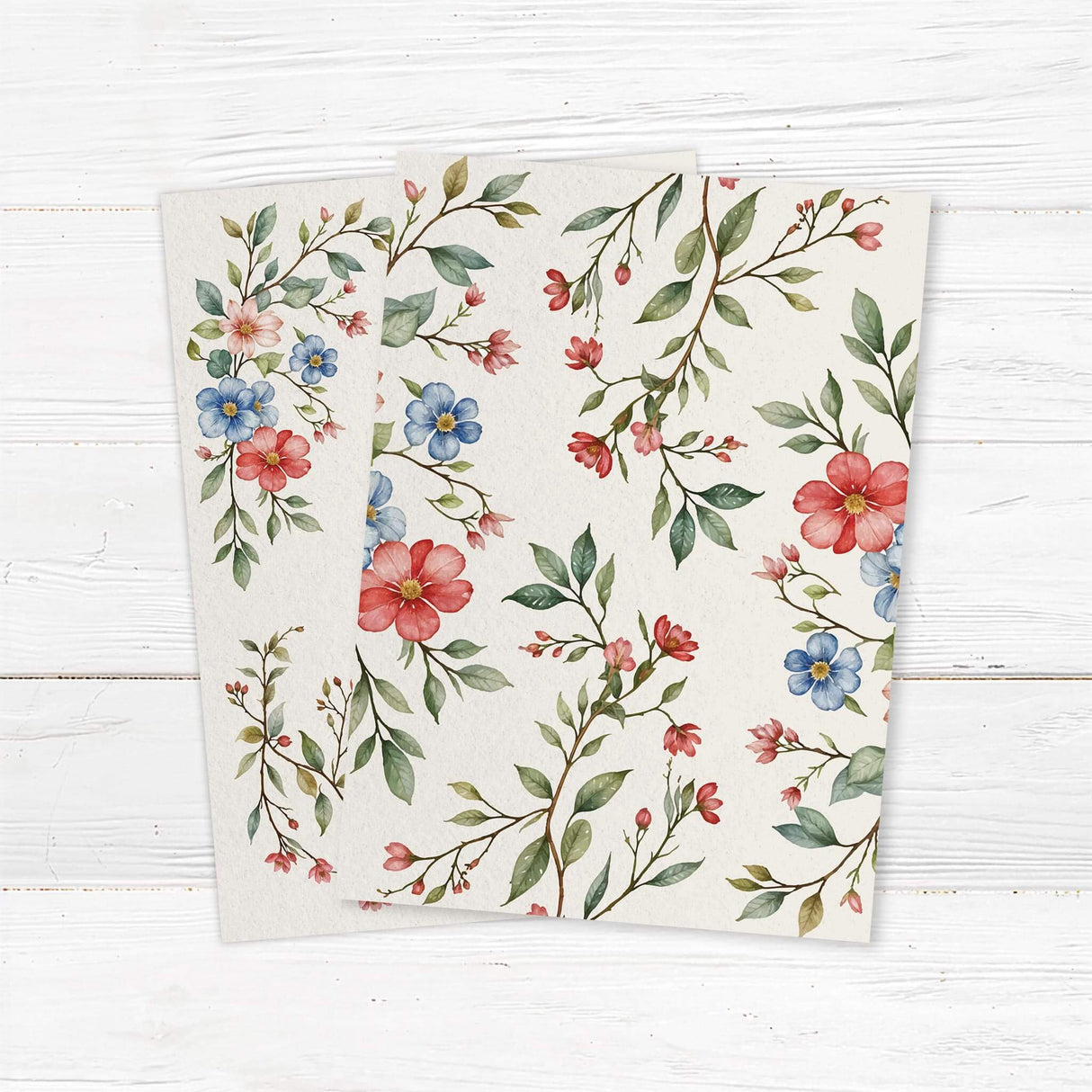 Elegant wedding invitation featuring a delicate watercolor floral design with red, blue, and pink flowers intertwined with green leaves. The layout is balanced with soft botanical elements framing the text, creating a romantic and timeless aesthetic. Back.