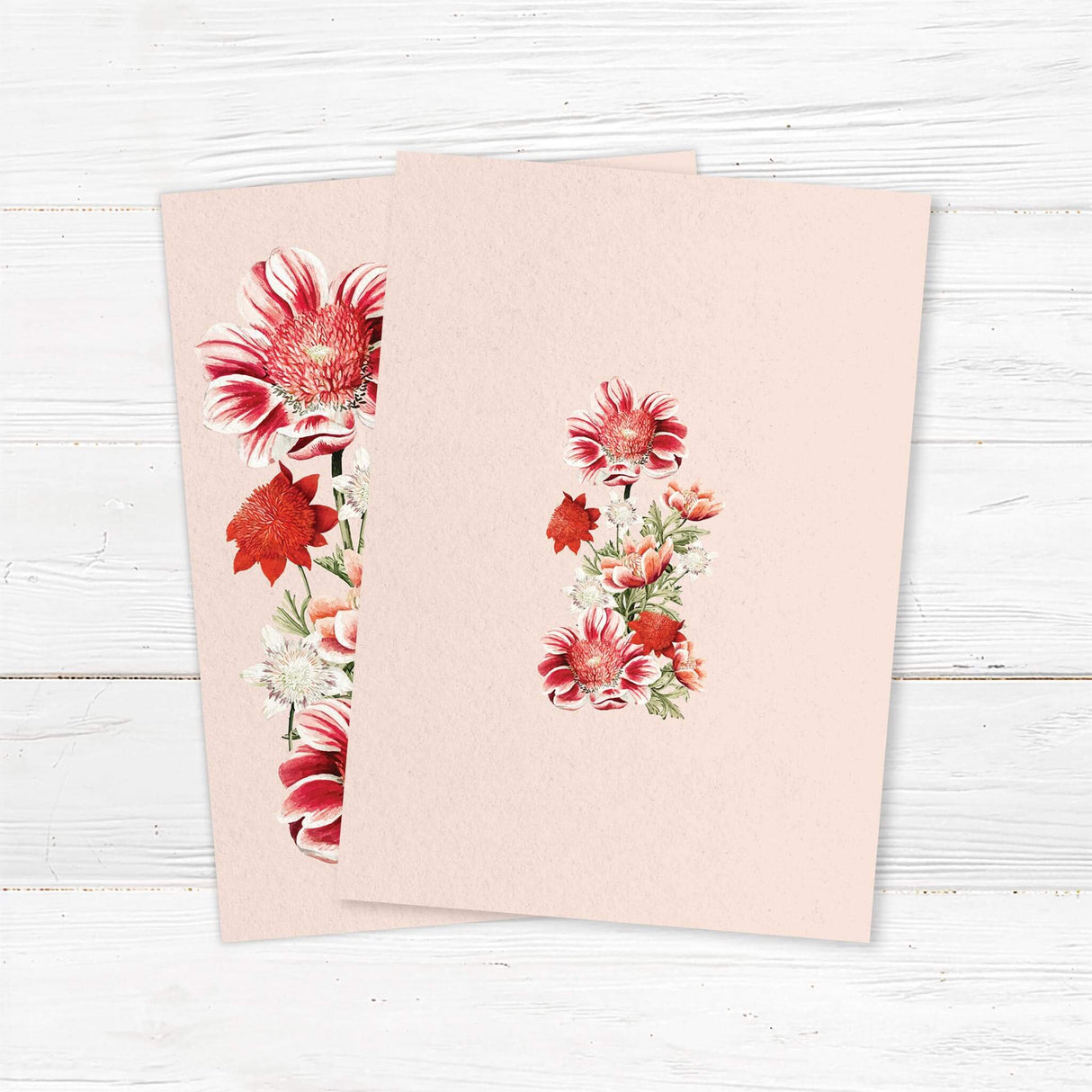 Wedding invitation back with bold red and coral watercolor florals along the sides, elegant serif and script fonts, printed on textured white cardstock. Warm and romantic summer design.