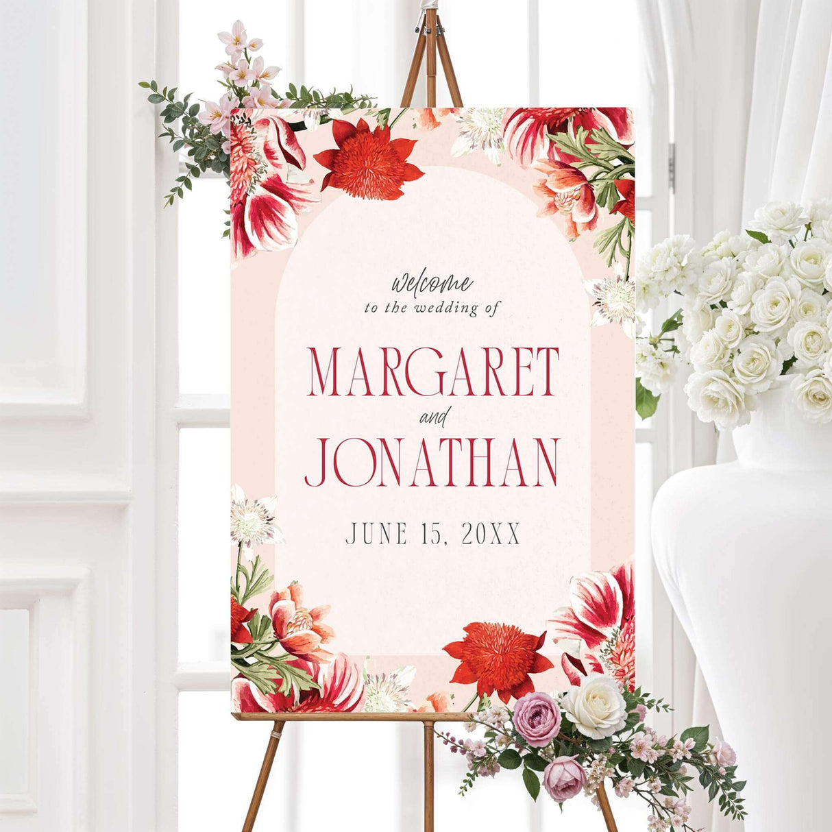 Wedding welcome sign featuring watercolor red and coral flowers, customizable names and date, and serif script fonts. Printed for ceremony entrances.