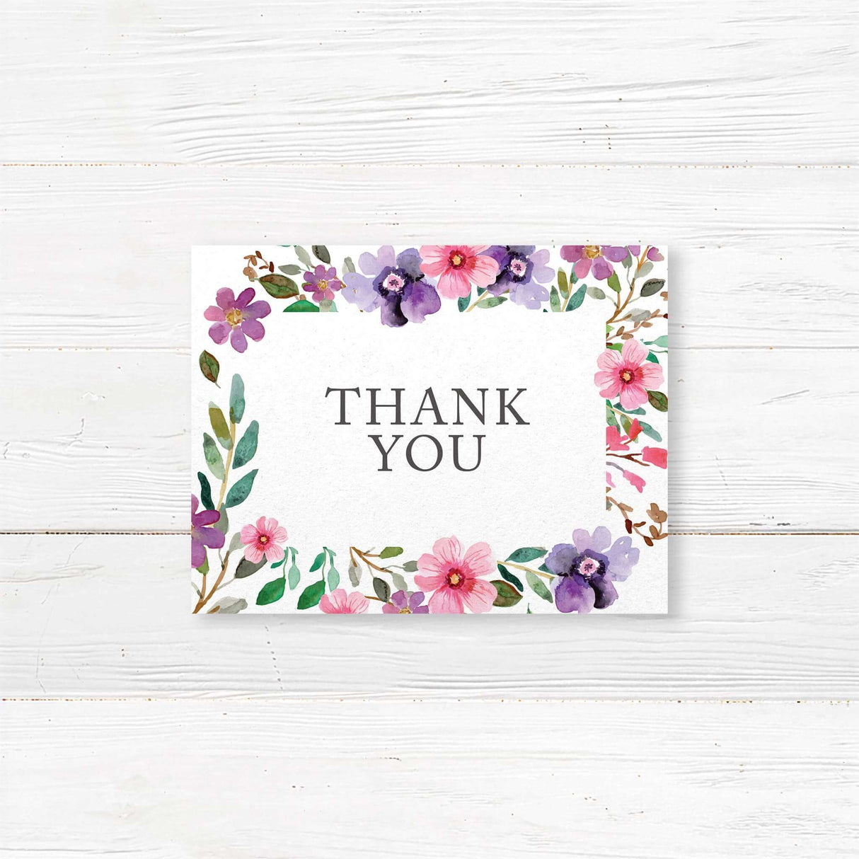 Beautiful floral wedding thank you card featuring soft pink and purple watercolor flowers. Printed on premium textured cardstock with a customizable message, perfect for expressing gratitude after your wedding celebration.
