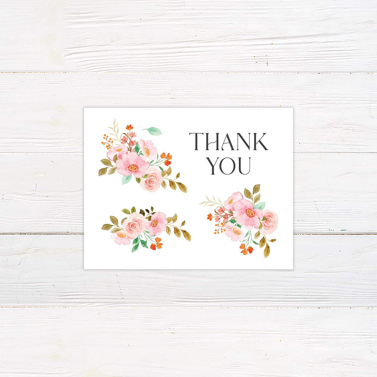 Thank you card with pink watercolor florals and elegant typeface, matching the wedding suite design.