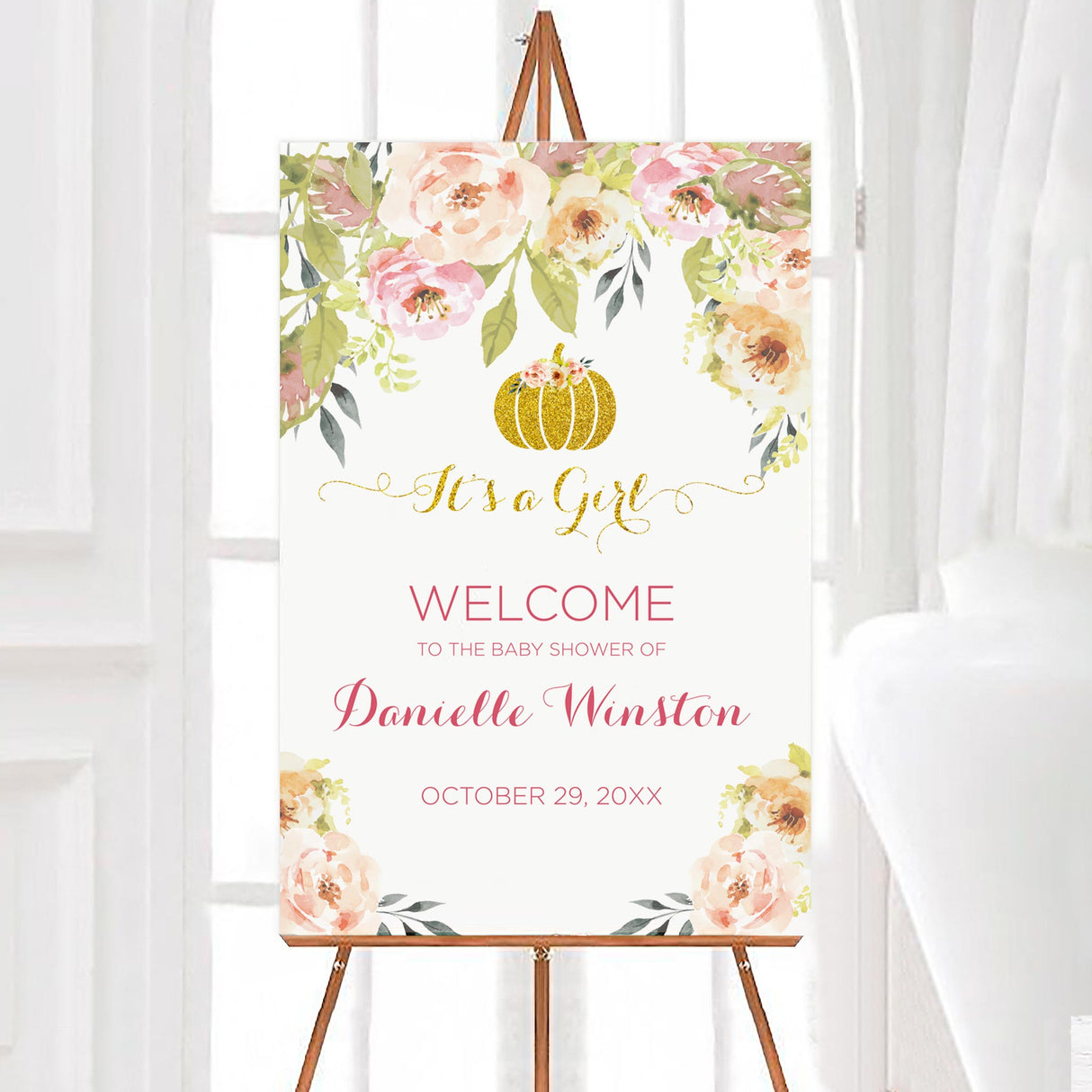 A sweet little pumpkin baby shower welcome sign with floral decorations and a gold pumpkin. The design uses soft pink and green colors.