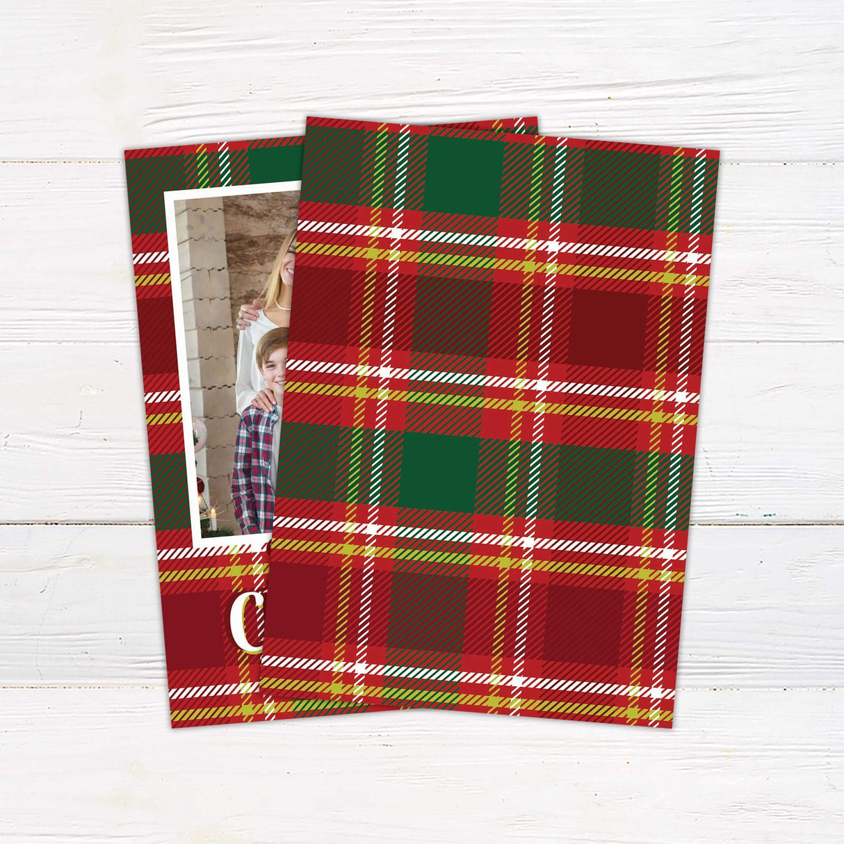 A Christmas card with a red and green tartan plaid border featuring a family portrait in the center. The card includes “Merry Christmas” and custom text. - back.