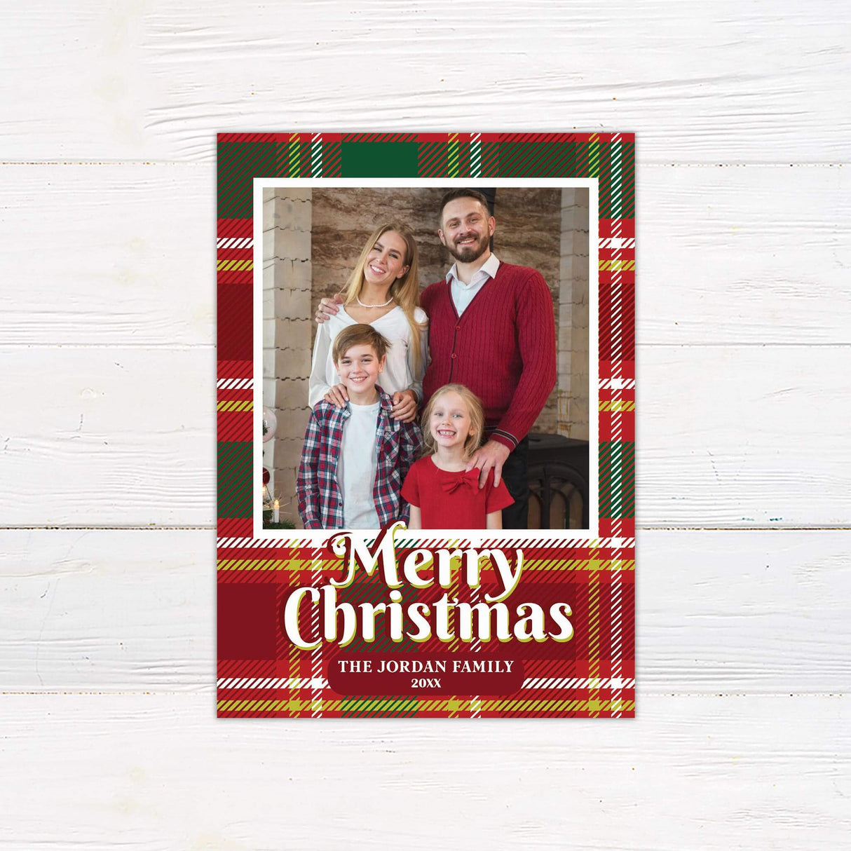 A Christmas card with a red and green tartan plaid border featuring a family portrait in the center. The card includes “Merry Christmas” and custom text.