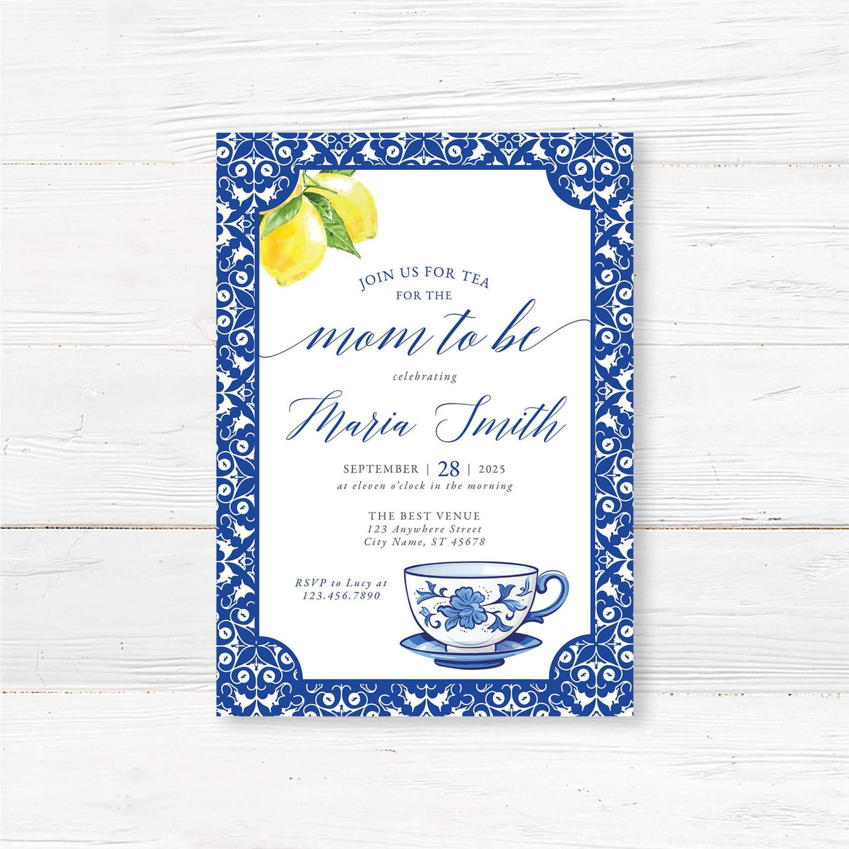 "Elegant blue and white tea party invitation featuring a classic ornate border, watercolor lemons, and a delicate floral teacup illustration. The design includes stylish script and serif fonts, creating a sophisticated and charming look. Perfect for tea party-themed celebrations with a timeless and elegant touch."