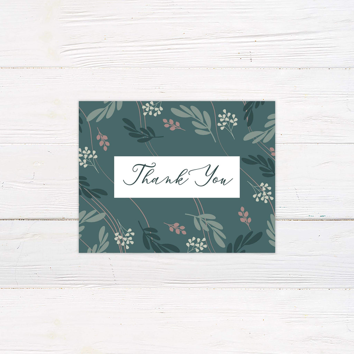 Thank you card with teal leaf illustrations and graceful script, designed to match the invitation suite.