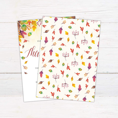 Thanksgiving Dinner invitation with autumn leaf design on wooden background