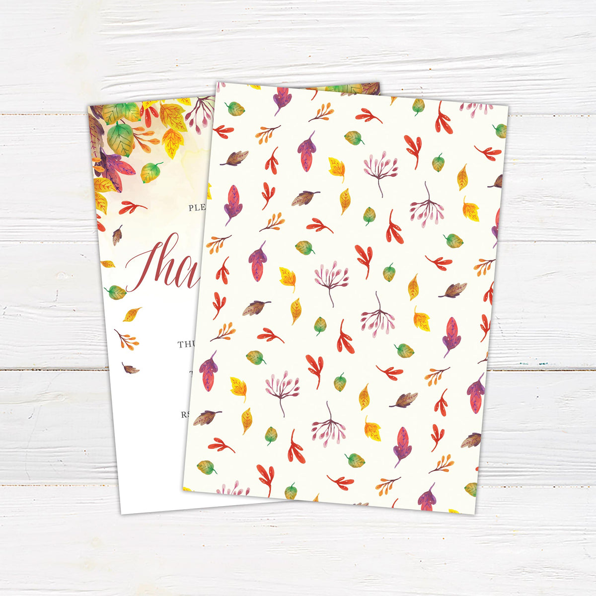 Thanksgiving dinner invitation featuring colorful watercolor fall leaves, botanical branches, burgundy script lettering, and customizable dinner details. The double-sided printed invitation includes a coordinating reverse design with scattered autumn foliage on a soft ivory background. - back.