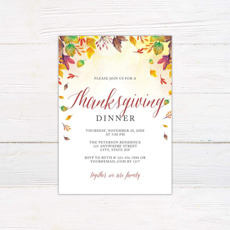 Thanksgiving Dinner invitation with colorful autumn leaves design on a white wooden background, perfect for festive celebrations.