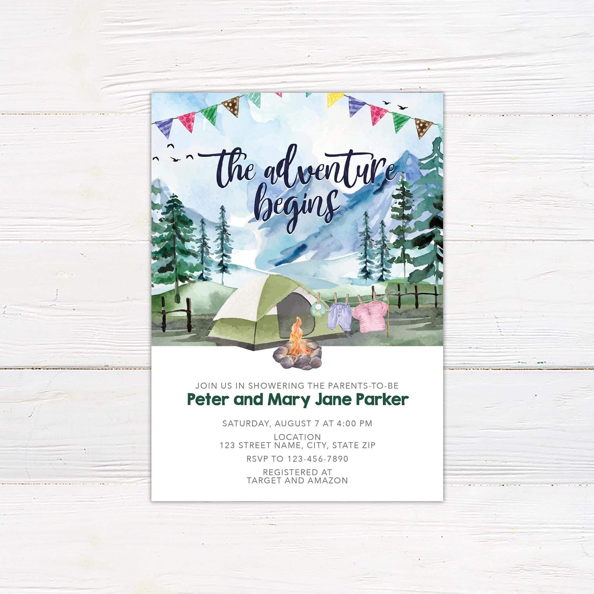 Rustic baby shower invitation featuring a watercolor camping scene with mountains, a tent, a campfire, and baby clothes on a clothesline. A perfect choice for adventure-themed, outdoor, or woodland baby showers.
