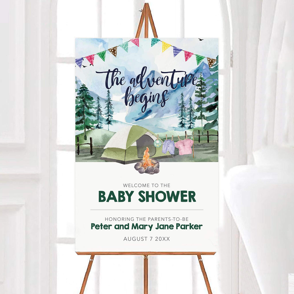 Camping-themed baby shower welcome sign featuring a watercolor mountain scene with a tent, campfire, and baby clothes on a clothesline. A charming way to greet guests at an adventure-themed or outdoor baby shower