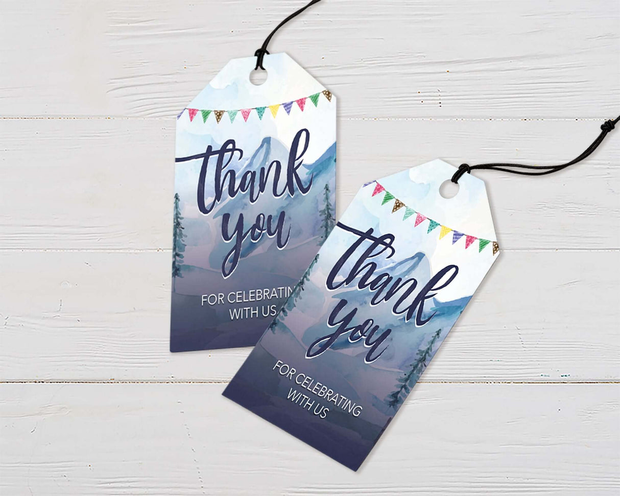Adventure-themed tags featuring a watercolor camping design with mountains, a campfire, and ‘The Adventure Begins’ text. Perfect for sealing envelopes, favor bags, or baby shower decorations.